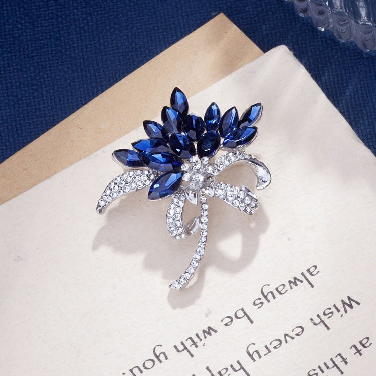 stylish woman wearing a rhinestone flower brooch