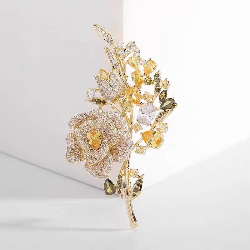 Purple rose brooch displayed on fabric