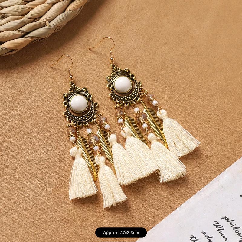 Feather tassel earrings on model