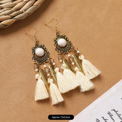 Feather tassel earrings on model