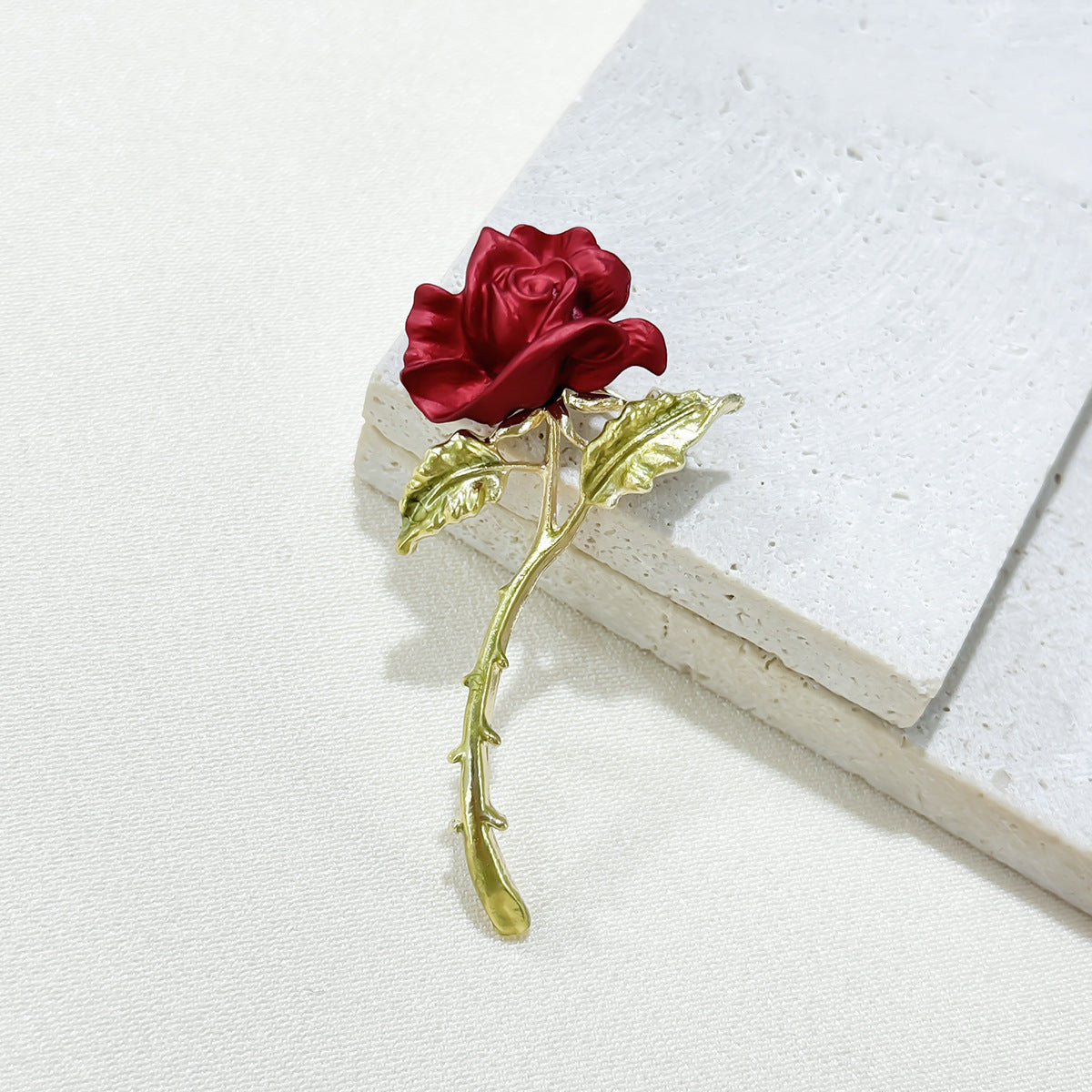 Close-up of Elegant Red Rose Brooch details