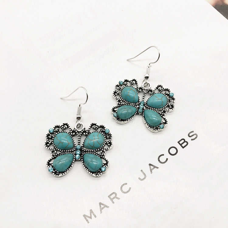 Flat lay display of necklace and earrings with turquoise details - image 6