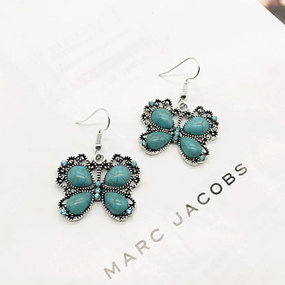 Flat lay display of necklace and earrings with turquoise details - image 6