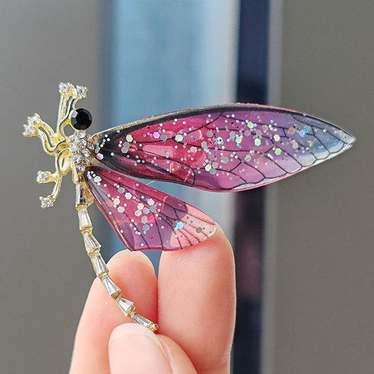 Vintage animal brooch displayed against patterned fabric