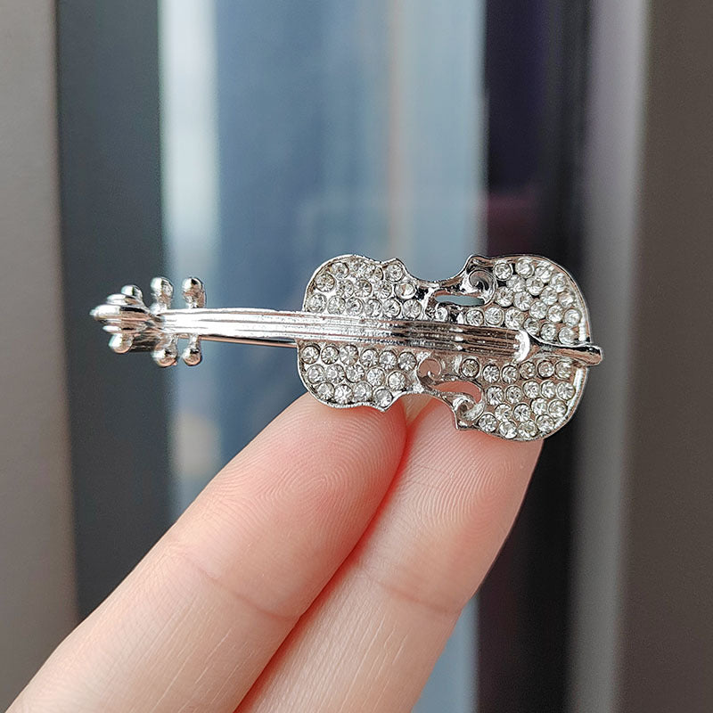 Close up of rhinestone detailing on violin brooch - image 8