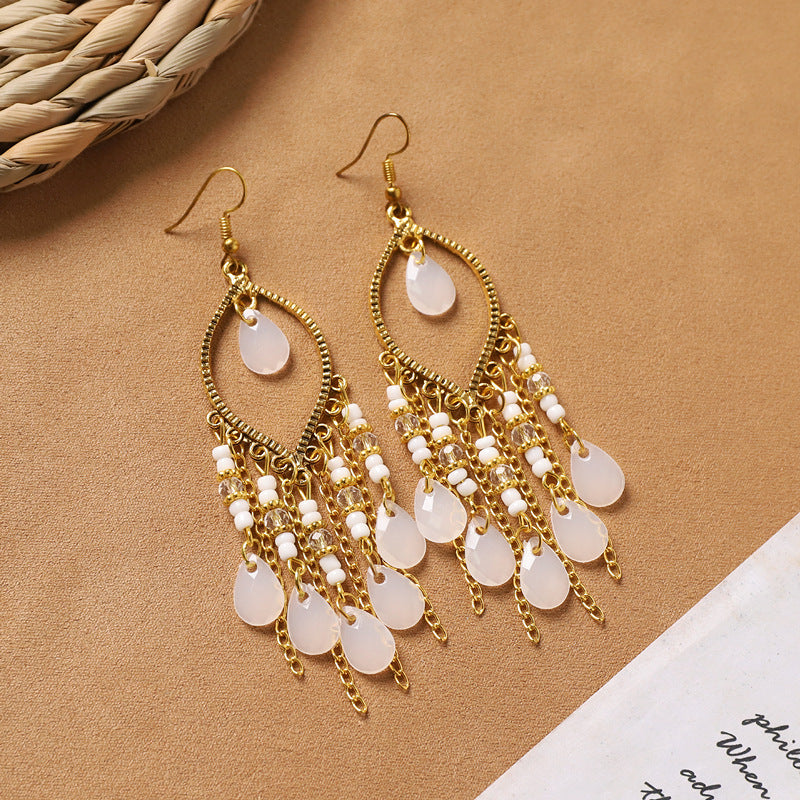Feather tassel earrings on model