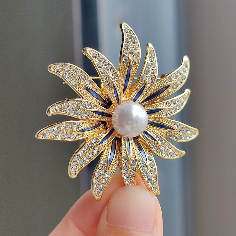 Pearl adorned brooch on cardigan