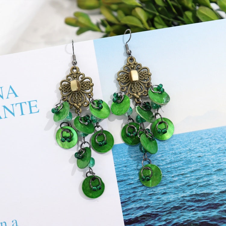 Casual outfit with shell earrings showcased