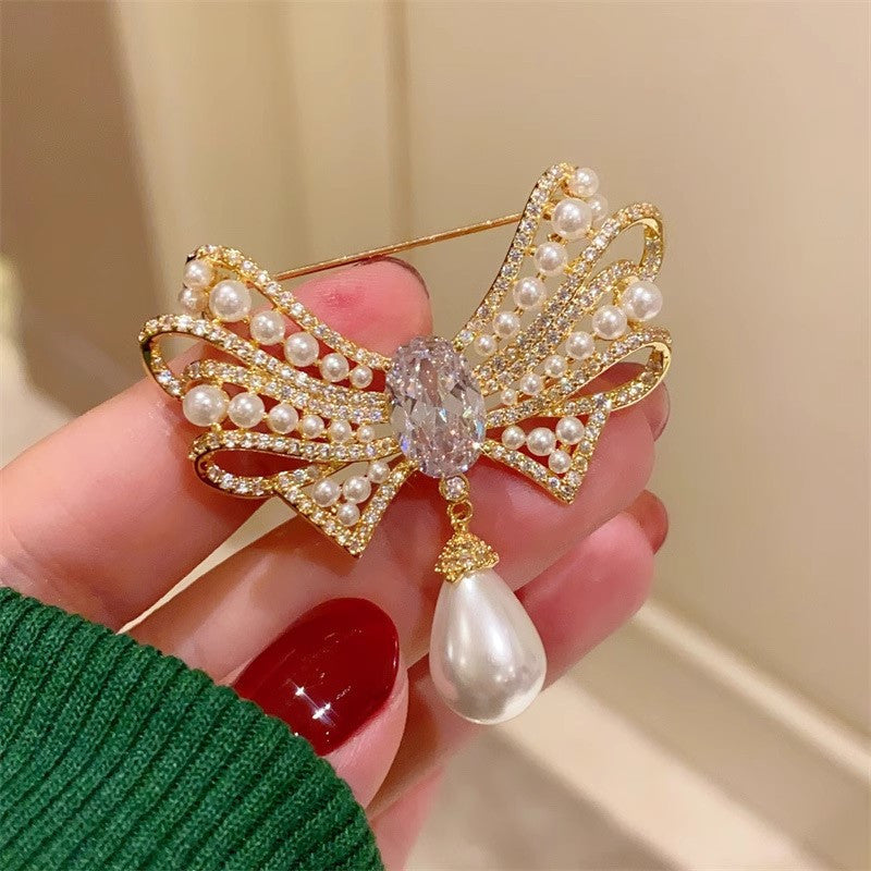 Gold bow brooch with pearl detail image 2