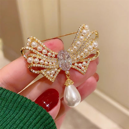 Gold bow brooch with pearl detail image 2