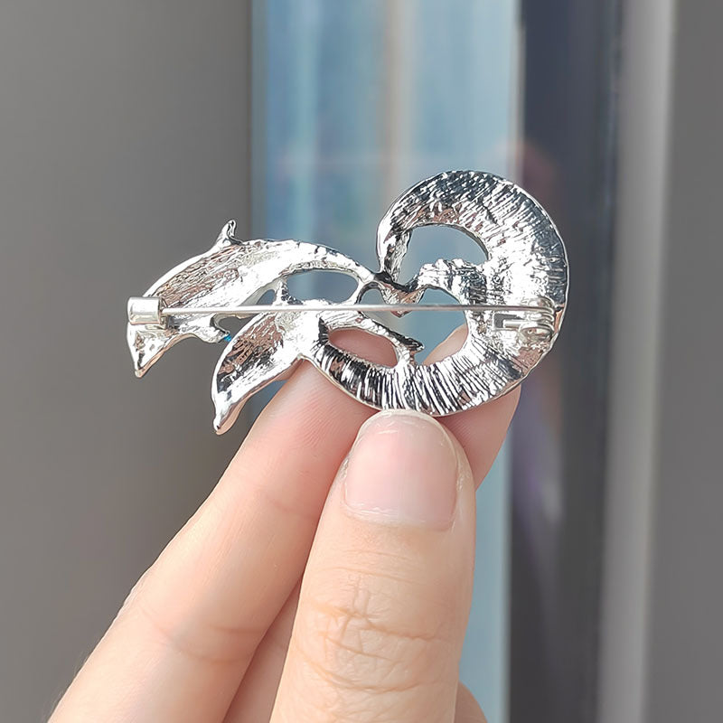 Dolphin brooch displayed on white background