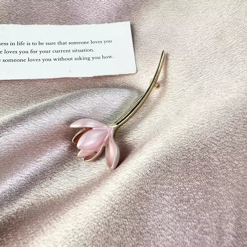 Detailed view of pink brooch with floral details