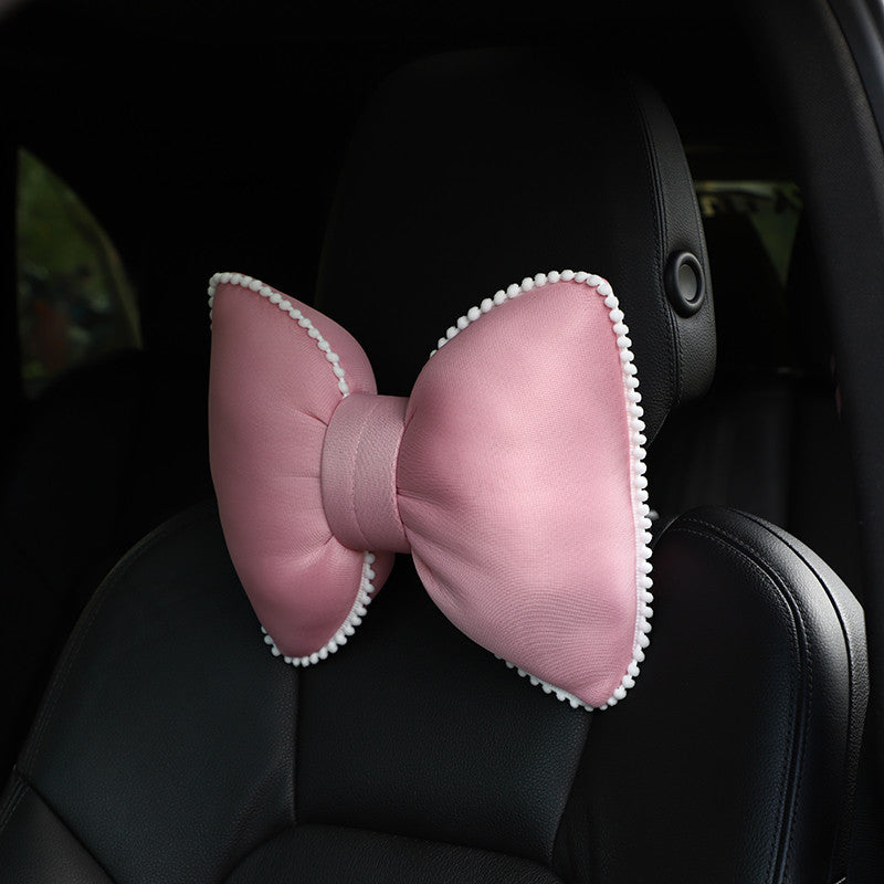 plush black headrest with camellia and butterfly knot design