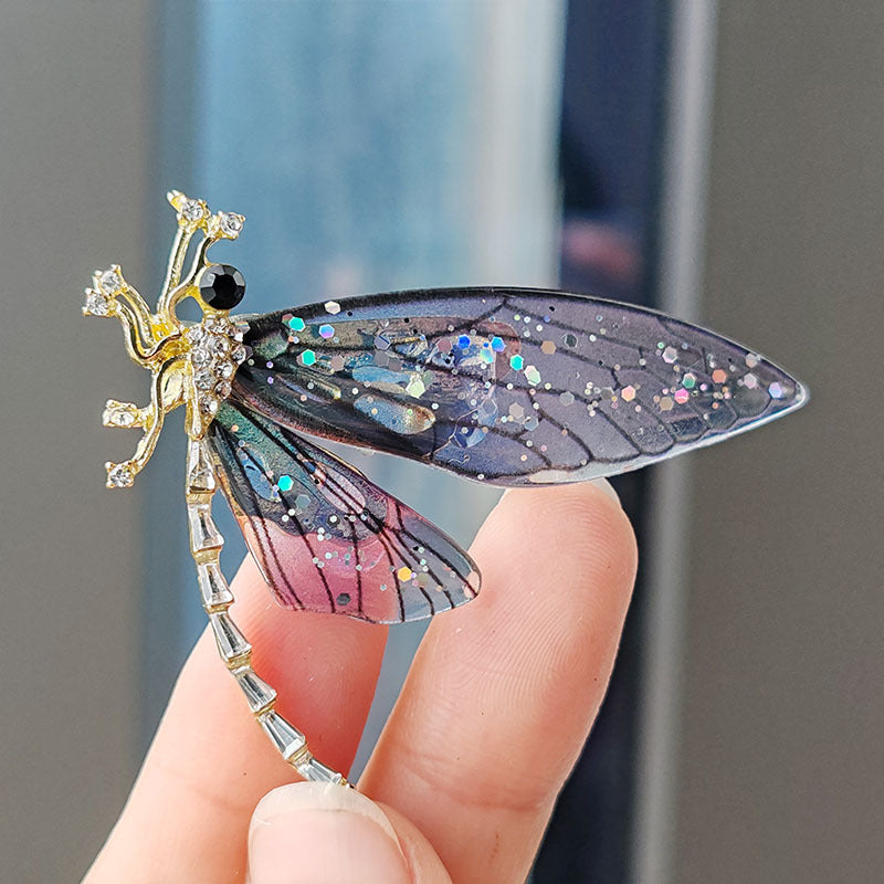 Charming acrylic dragonfly brooch pin on white background