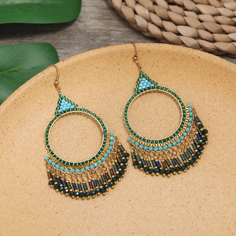 Wearing bohemian tassel earrings outdoors image 5