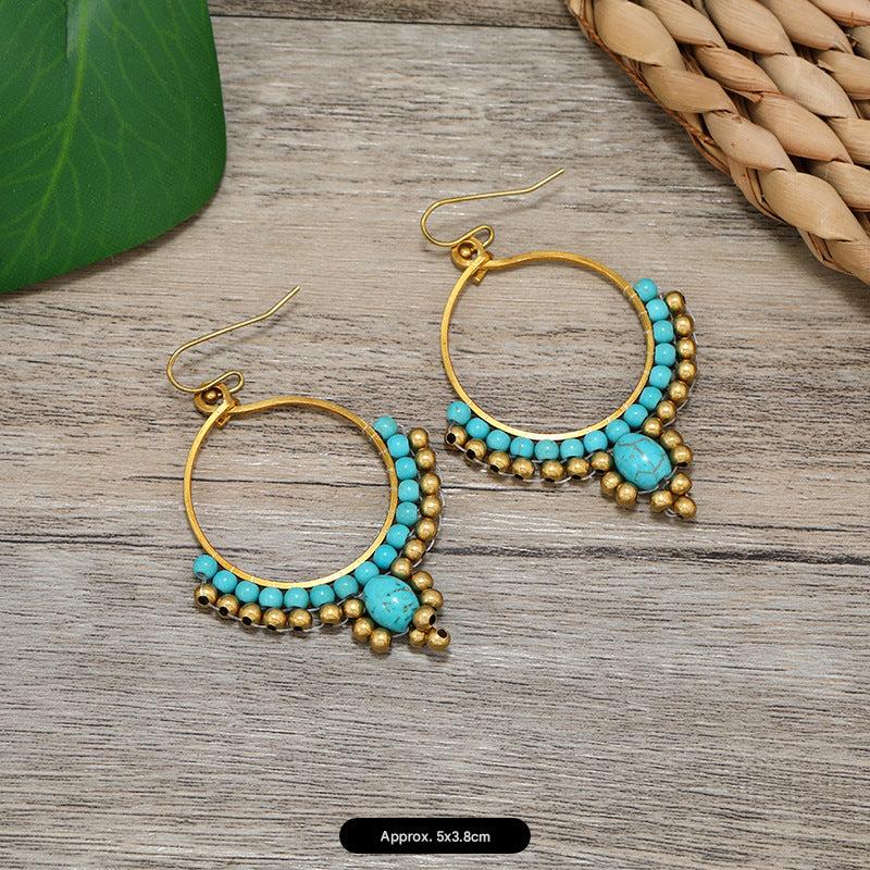 Women styling elegant tassel earrings