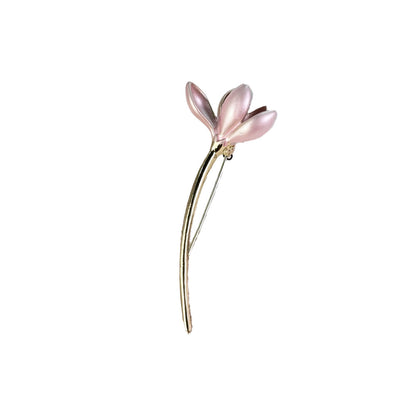 Close-up of floral brooch showcasing design and shine