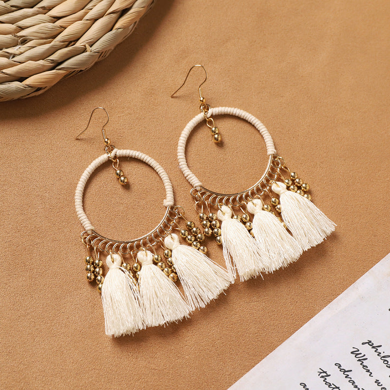 Feather tassel earrings on model