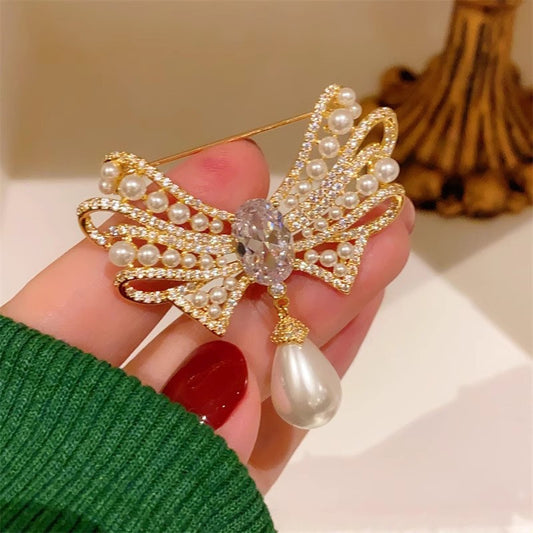 Gold bow brooch with pearl detail image 2