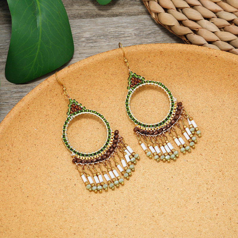 Women styling elegant tassel earrings