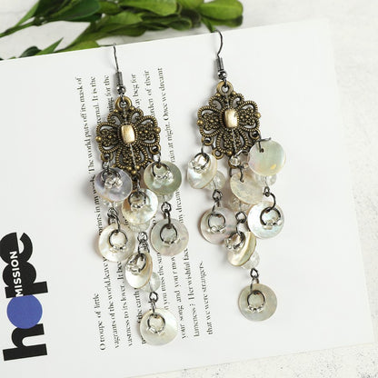 Casual outfit with shell earrings showcased