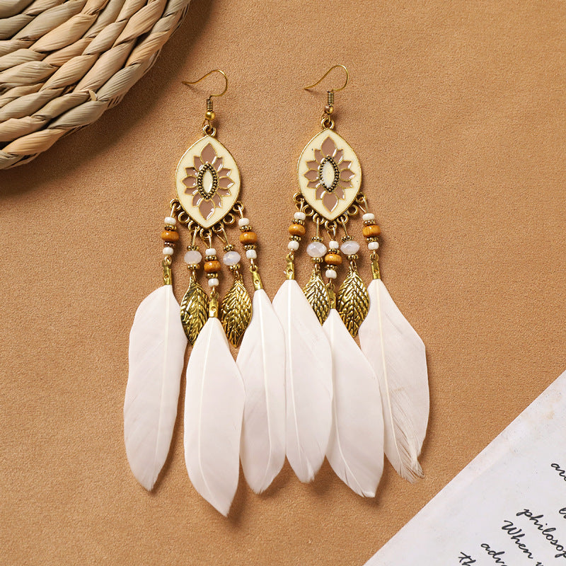 Feather tassel earrings on model