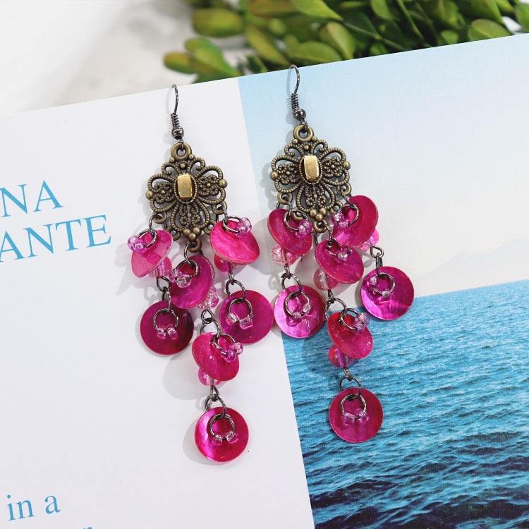 Casual outfit with shell earrings showcased