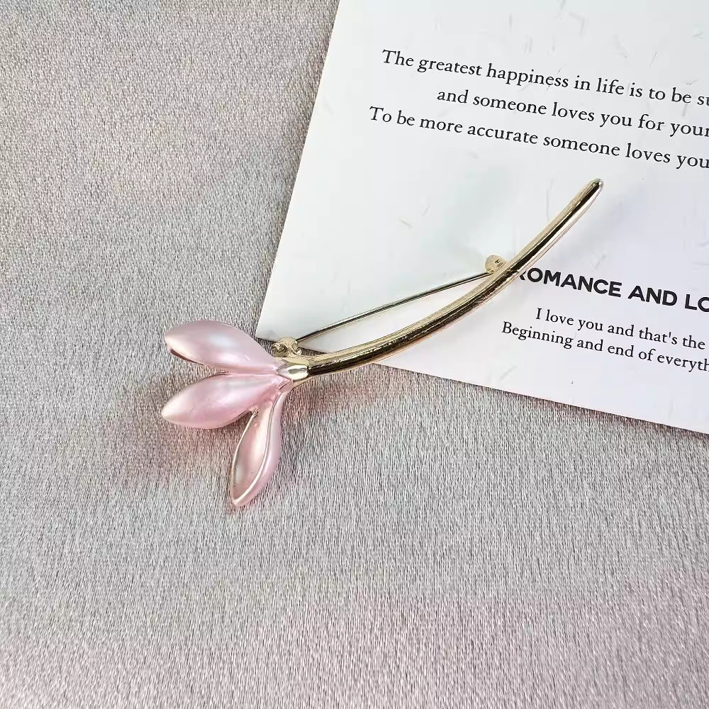 Vintage style flower brooch pin against a neutral background