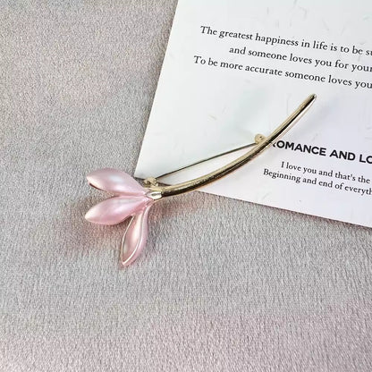 Vintage style flower brooch pin against a neutral background