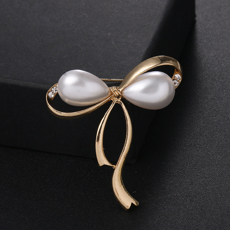 Elegant Pearl Bow Brooch with Rhinestones - Image 1