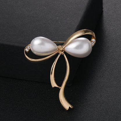 Elegant Pearl Bow Brooch with Rhinestones - Image 1