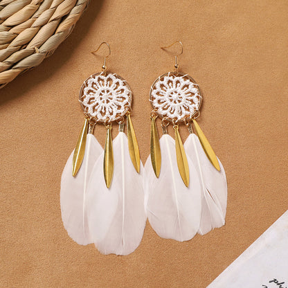 Feather tassel earrings on model