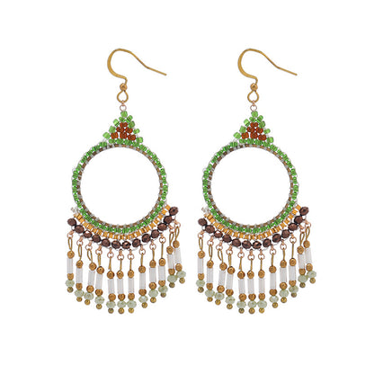 Elegant tassel earrings against a sunny background